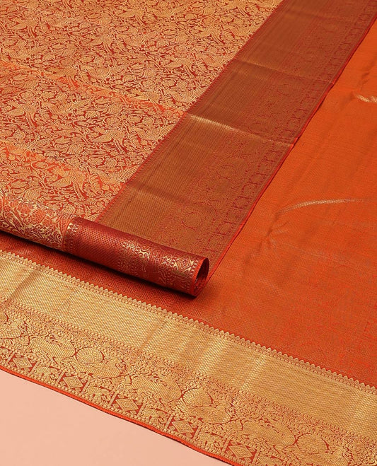 Orange Kanchipuram Wedding Silk Saree, Artfully Detailed with Jacquard Design on Its Body, Highlighted by Zari Border of Thilakam, Kuyil Kann, Diamond, Mayil, Yaali, and Yaanai Designs, Grand Jaal Pallu, and Paired with a Matching Blouse
