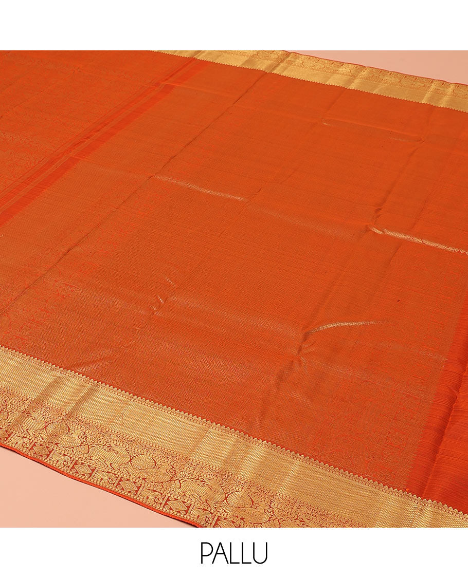 Orange Kanchipuram Wedding Silk Saree, Artfully Detailed with Jacquard Design on Its Body, Highlighted by Zari Border of Thilakam, Kuyil Kann, Diamond, Mayil, Yaali, and Yaanai Designs, Grand Jaal Pallu, and Paired with a Matching Blouse