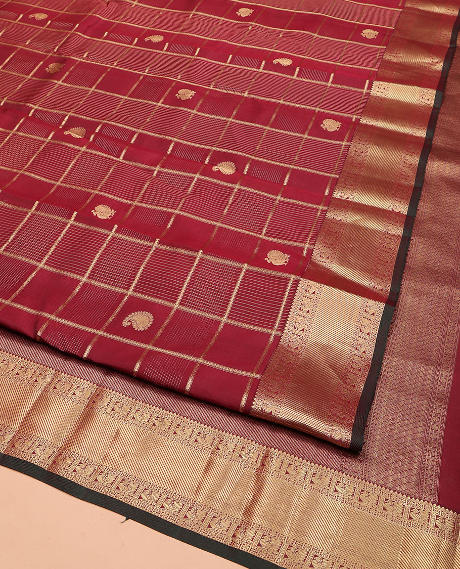 Maroon Vasundhara Silk Saree, Embellished with Zari Buttas and Zari Checks All Over Its Body, Highlighted  by a Zari Border of Rekku, Kamalam, Diamond, and Mayil Designs, Diagonally Zari Striped Pallu, and Paired with a Contrast Blouse