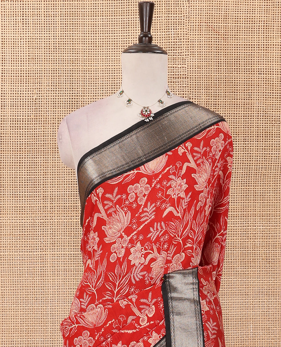 Red floral printed muga silk saree, contrast zari traditional temple border, and gleaming zari striped pallu