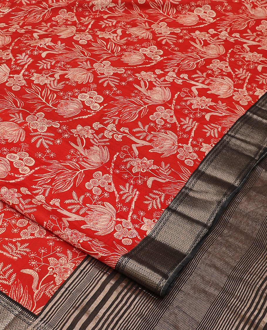 Red floral printed muga silk saree, contrast zari traditional temple border, and gleaming zari striped pallu