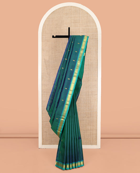 Green Kanchipuram Silk Saree, Gleamed Up with Zari Buttas on Its Body, Complemented by a Contrast One-Sided Border of Banaras, and Jaal Designs, Pallu of Zari Designs, and Comes Without a Blouse