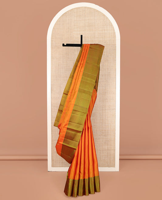 Orange Kanchipuram Silk Saree, Subtly Sparkled with Mayil-Chakram Buttas All Over Its Body, Complemented by a Contrast Border of Rekku, Kamalam, Poun, Chakram, Kuyil Kann, and Then Kuli Kann Designs, Jaal Design Pallu, and Paired with a Contrast Blouse