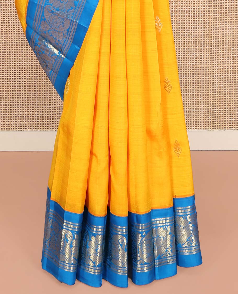 Yellow Kanchipuram Silk Saree, Ornamented with Zari Buttas on Its Body, Complemented by a Contrast One-Sided Korvai Border of Banaras, Muthu, Floral and Paisley Designs, Pallu of Intricate Designs, and Comes Without a Blouse