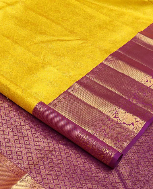 Yellow jacquard wedding silk saree, contrast border of thilakam, rudraksham, and mayil designs, and ogee design pallu