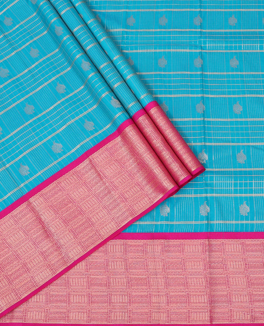 Light Blue Art Silk Pavadai Material Set Featuring a Zari Butta Enclosed Checked Skirt, Complemented by a Contrast Checked Zari Woven Border, and Paired with a Contrast Blouse