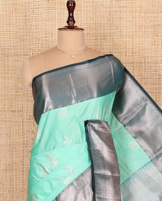 Turquoise Budget Silk Saree, Gleamed Up with Floral Zari Buttas All Over Its Body, Complemented by Contrast Border of Traditional Designs Woven in Zari, Beautifully Bedecked Pallu, and Paired with a Contrast Blouse