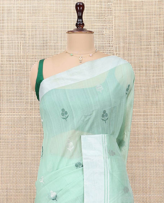 Green Chanderi Cotton Saree, Subtly Decked up with Floral Buttas All Over Its Body, Highlighted by a Bavanji Border, Pallu Steeped with Zari Stripes, and Paired with a Matching Blouse