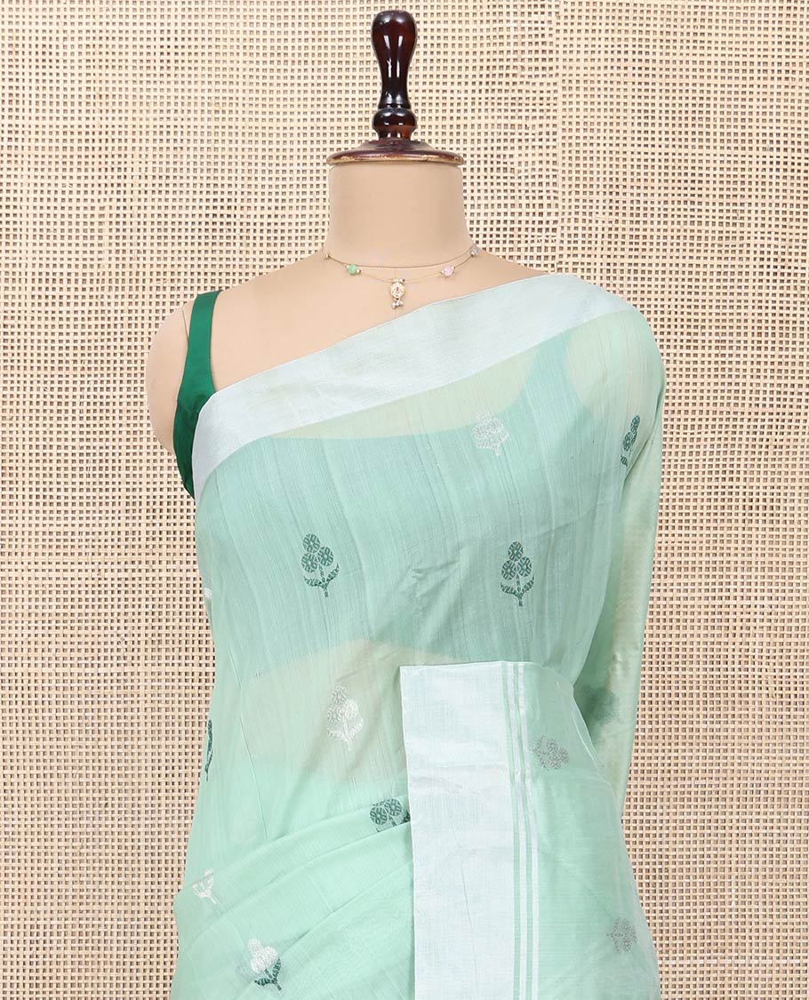 Green Chanderi Cotton Saree, Subtly Decked up with Floral Buttas All Over Its Body, Highlighted by a Bavanji Border, Pallu Steeped with Zari Stripes, and Paired with a Matching Blouse