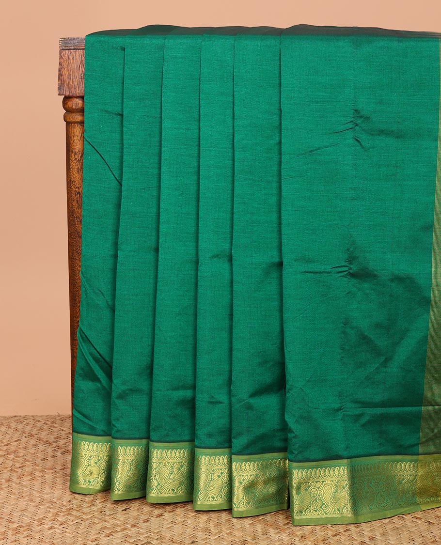 Green Plain Poly Cotton Saree, Complemented by a Contrast Traditional Zari Border of Peacock Designs, Pallu Steeped with Paisley Designs, and Paired with a Contrast Blouse