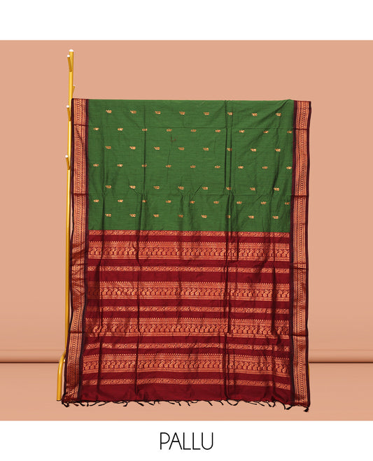 Green Kalyani Cotton Saree, Accentuated with Buttas All Over Its Body, Complemented by a Contrast Traditional Zari Design Temple Border, Pallu Features Traditional Zari Designs, and Paired with a Contrast Blouse