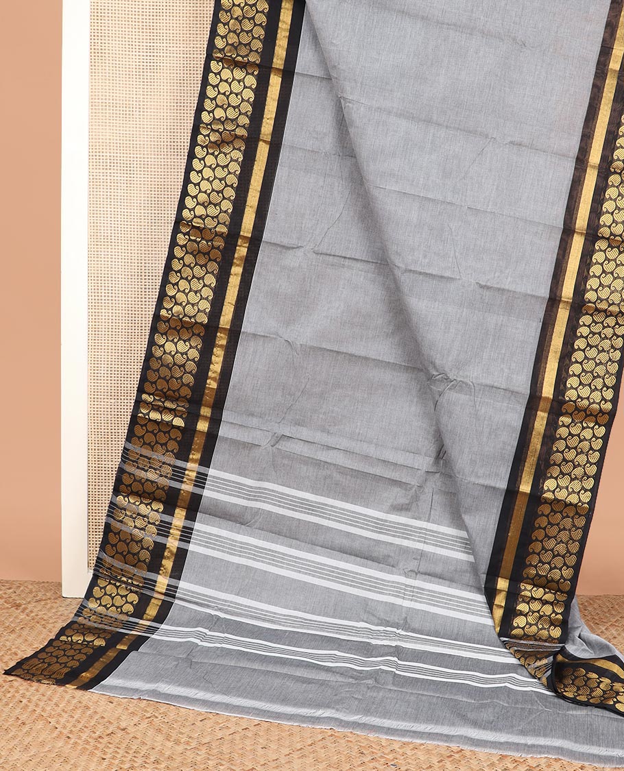 Grey plain Chettinad cotton saree, contrast zari border steeped with paisleys, and striped pallu