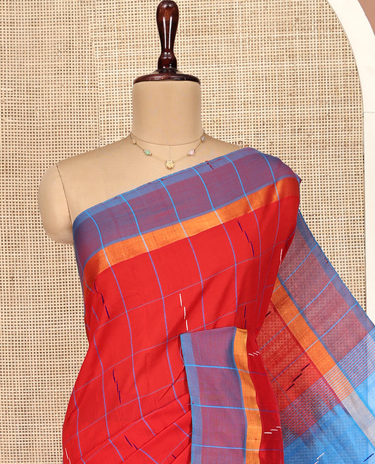 Red Poly Cotton Saree, Bedecked with Butta Enclosed Checks on Its Body, Complemented by Contrast Border, Pallu Steeped with Stripes, and Paired with a Contrast Blouse