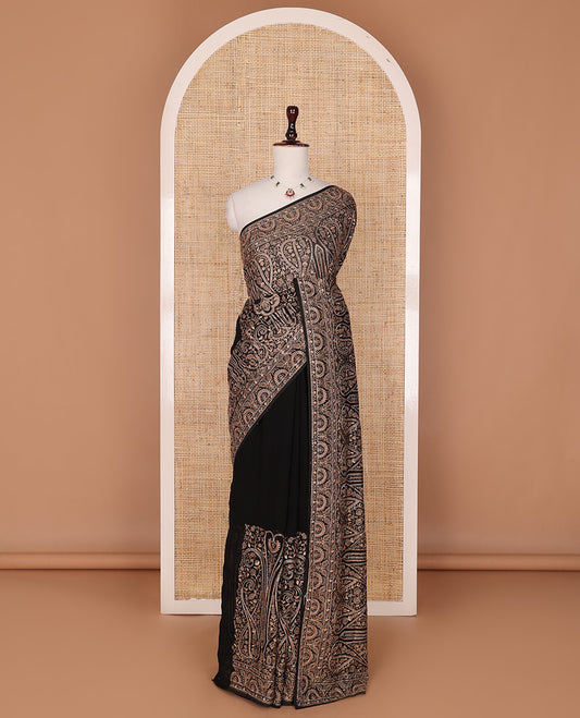 Black base antique gold thread embroidered designer saree features Mughal style floral, and paisleys