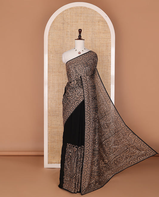 Black base antique gold thread embroidered designer saree features Mughal style floral, and paisleys