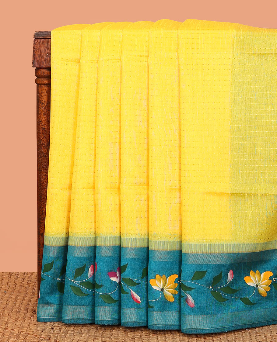 Yellow dobbly-style buttas dupion saree, contrast painting-style floral creeper design border, and buttas pallu