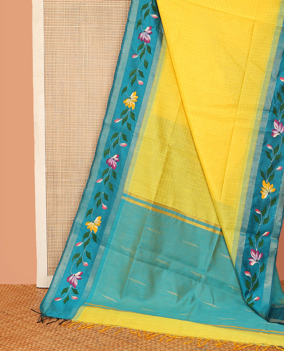 Yellow dobbly-style buttas dupion saree, contrast painting-style floral creeper design border, and buttas pallu
