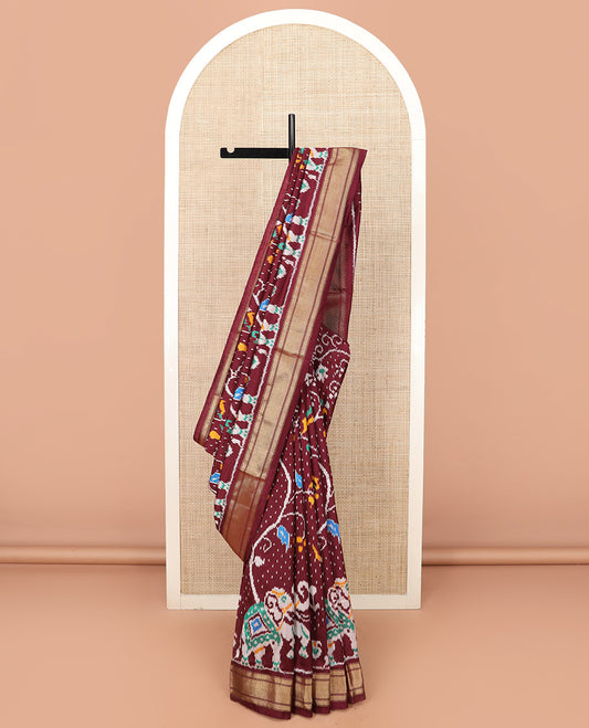 Maroon Ikkat Silk Saree with Colourful Elephant and Free-Style Ikkat Buttas, a Subtly Woven Zari Border, a Vibrantly Woven Pallu of Ikkat Patterns, and a Plain Blouse