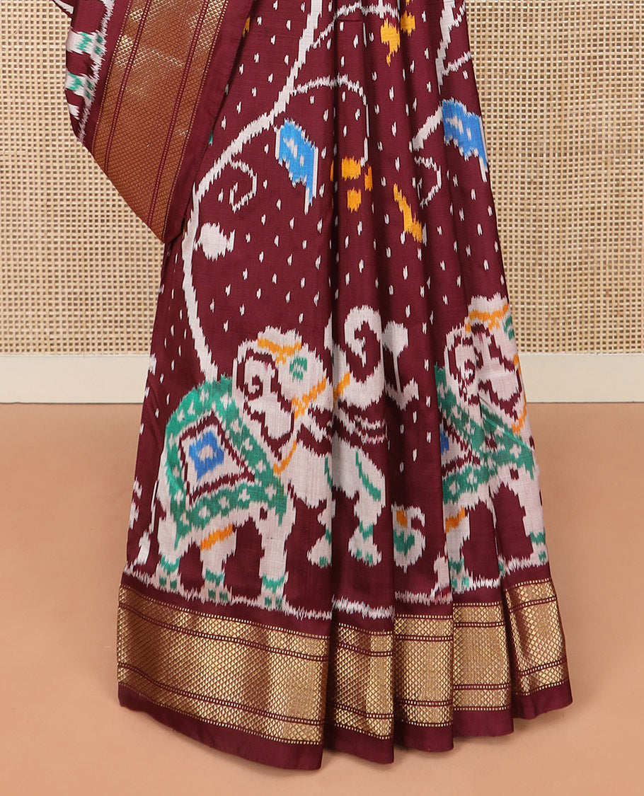 Maroon Ikkat Silk Saree with Colourful Elephant and Free-Style Ikkat Buttas, a Subtly Woven Zari Border, a Vibrantly Woven Pallu of Ikkat Patterns, and a Plain Blouse