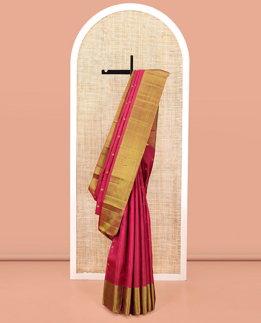 Red Kanchipuram Designer Silk Saree, Subtly Sparkled With Buttas All Over Its Body, Complemented by Contrast Border of Rekku, Rudraksham, Then Kuli Kann, Laddu Kamalam, and Mayil Kann Designs, Jaal Pallu and Paired with a Contrast Blouse