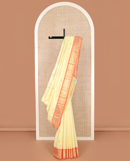 Cream zari buttas Kanchipuram silk saree, contrast one-sided border of banaras, chakram, and mayil kann designs, and zari design pallu