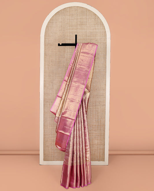 Pink Kanchipuram Tissue Silk Saree, Gracefully Embellished with Floral Jaal Jacquard Design On Its Body, Complemented by Zari Border of Thilakam Mokku, Muthu, and Mayil Kann Designs, Grandly Decked Up Pallu and Paired with a Matching Blouse