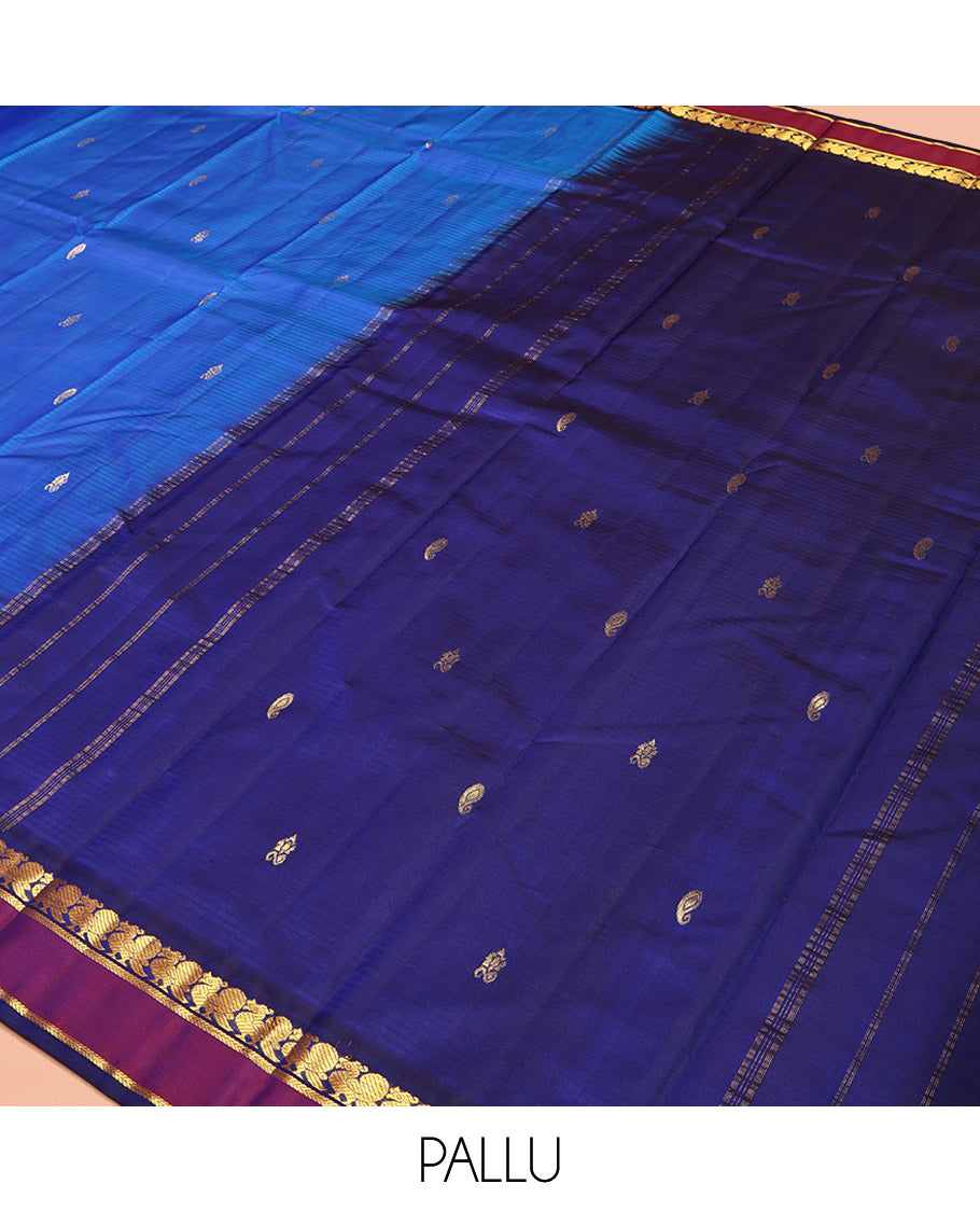 Blue Kanchipuram Silk Saree, Sparsely Sparkled with Vazhaipoo Stripes and Zari Buttas on Its Body, Complemented by Contrast Rettai Pettu Border of Mayil, and Kathir Designs, Zari-Striped Pallu, and Paired with a Contrast Blouse