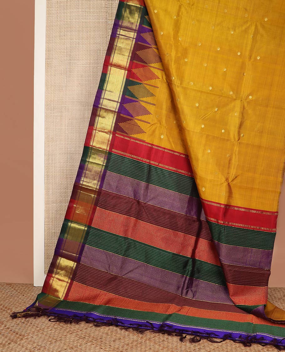Mustard zari buttas silk saree, contrast one-sided temple border of muthu, kathir & zari stripes & kaleidoscopic-colored striped pallu of zari stripes