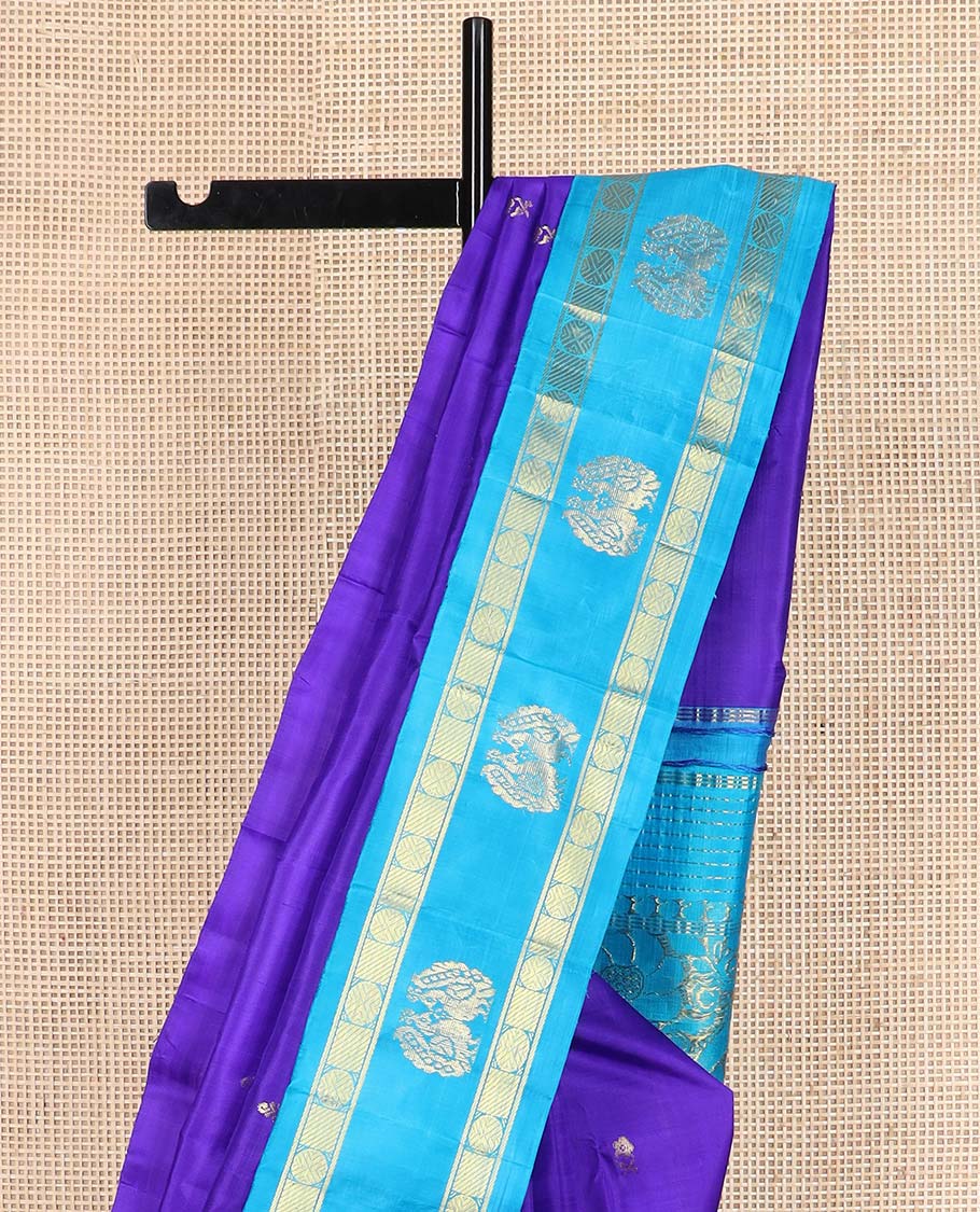 Blue zari buttas Kanchipuram silk saree, contrast one-sided korvai border of rudraksham and mayil designs, and floral design pallu