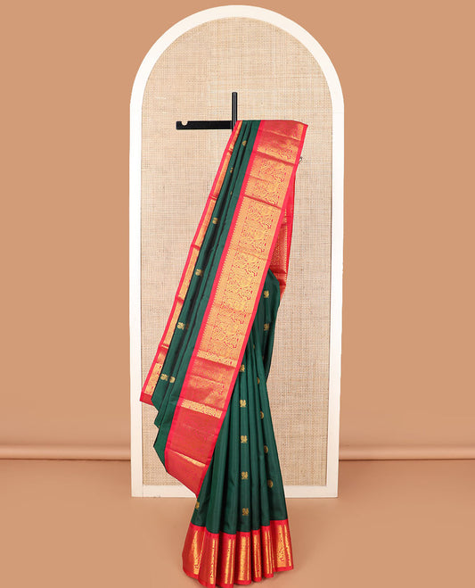 Green mayil chakram buttas Kanchipuram silk saree, contrast border of thilakam mokku, cross kamalam, and mayil designs, and zari design pallu