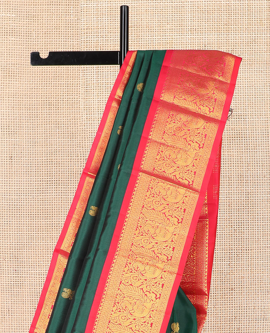 Green mayil chakram buttas Kanchipuram silk saree, contrast border of thilakam mokku, cross kamalam, and mayil designs, and zari design pallu