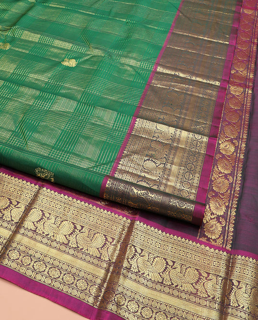 Green Kanchipuram Silk Saree Detailed with Zari Buttas and Checks, Highlighted by Contrast One-Sided Border of Thilakam Mokku, Kamalam, Mayil, Rudraksham, and Kamalam Designs, Grand Pallu of Butta Enclosed Jaal Design, and Comes Without a Blouse