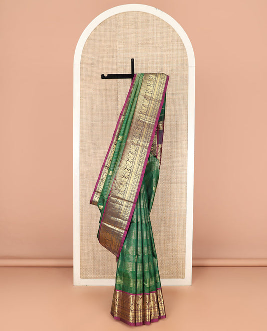 Green Kanchipuram Silk Saree Detailed with Zari Buttas and Checks, Highlighted by Contrast One-Sided Border of Thilakam Mokku, Kamalam, Mayil, Rudraksham, and Kamalam Designs, Grand Pallu of Butta Enclosed Jaal Design, and Comes Without a Blouse