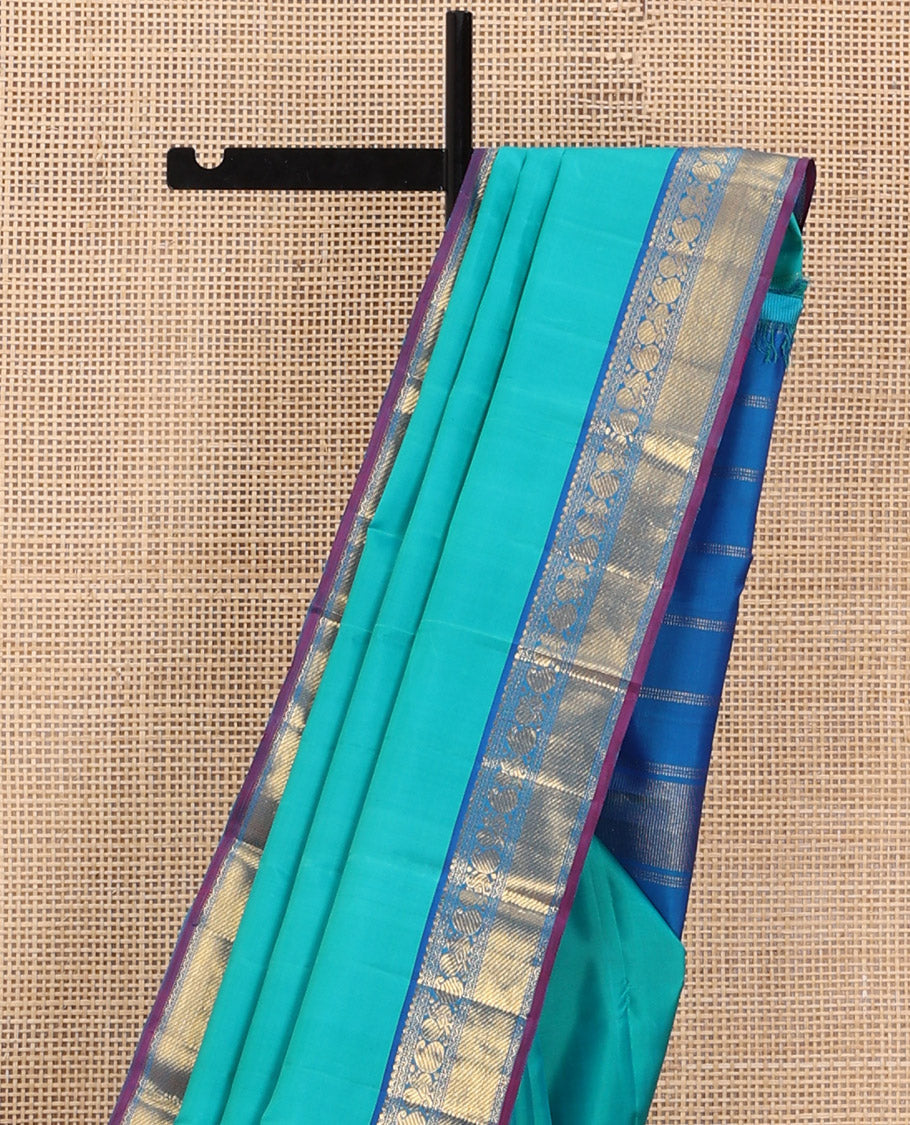 Blue Plain Kanchipuram Silk Saree, Complemented by Contrast Border of Salngai, Muthu, Rekku, Manga, Mayil, and Zari Stripes, Subtly Sparkled Pallu, and Paired with a Contrast Blouse