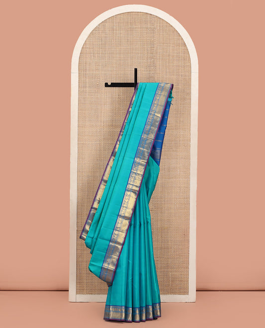 Blue Plain Kanchipuram Silk Saree, Complemented by Contrast Border of Salngai, Muthu, Rekku, Manga, Mayil, and Zari Stripes, Subtly Sparkled Pallu, and Paired with a Contrast Blouse