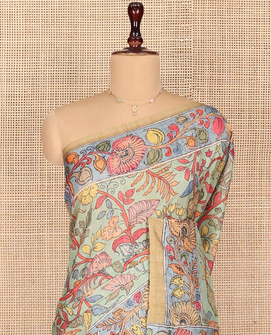 Light Pista Semi-Tussar Saree Colorfully Highlighted with Kalamkari-Style Floral Vine Print, Captivating Contrast Border Printed with Floral Motifs, Pallu Depicting Krishna and Gopis Print, and Paired with a Contrast Printed Blouse