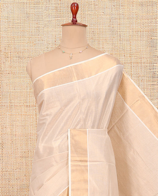 Cream Plain Kerala Cotton Saree, a Zari Bavanji Border, a Self-Pallu, and Paired with a Matching Blouse