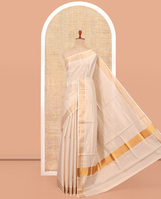Cream Plain Kerala Cotton Saree, a Zari Bavanji Border, a Self-Pallu, and Paired with a Matching Blouse