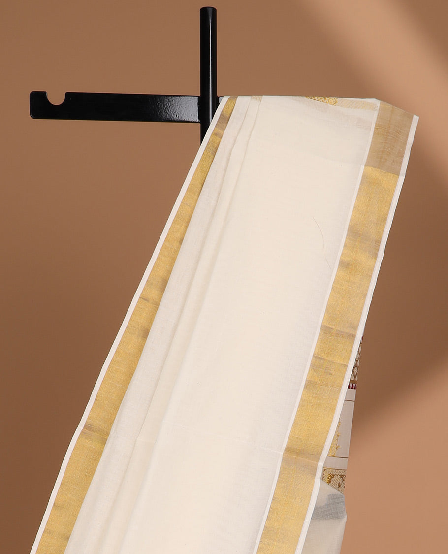 Cream kerala saree with zari designs, zari border & pallu of peacock designs