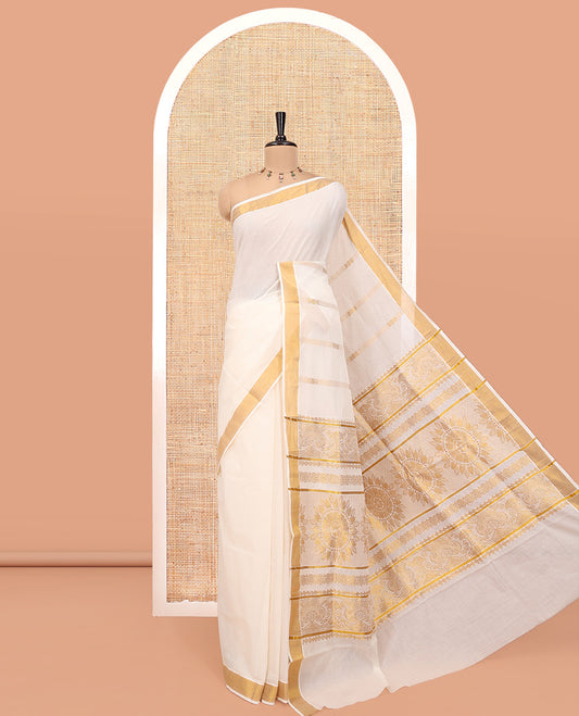 Cream Kerala Cotton Saree, Woven with Zari Stripes All Over Its Body, a Subtle Bavanji Border, Pallu Depicts Intricate Designs, and Paired with a Matching Blouse