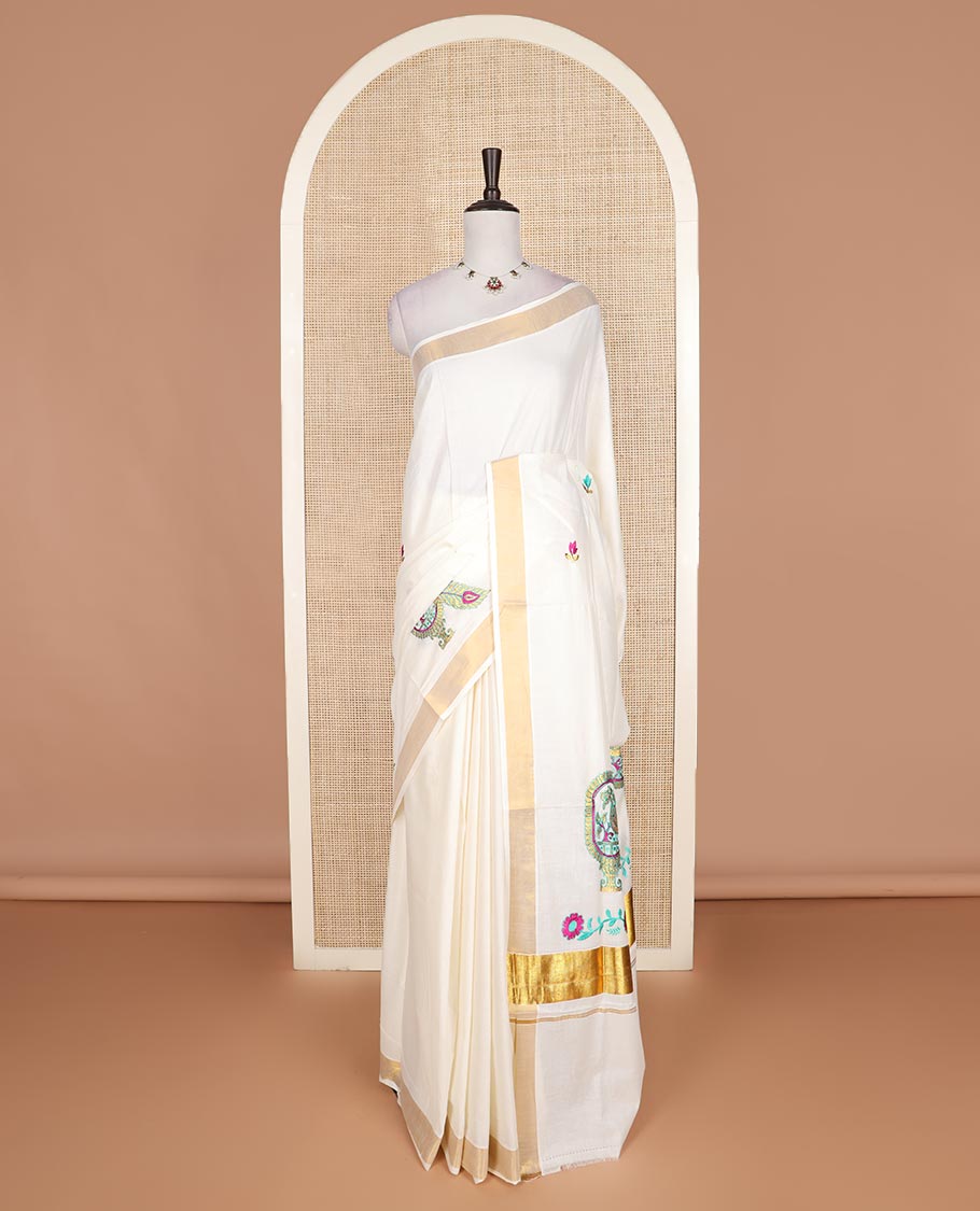 Cream floral motifs embroidered Kerala cotton saree, bavanji border, and peacock embroidered pallu