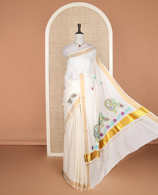 Cream floral motifs embroidered Kerala cotton saree, bavanji border, and peacock embroidered pallu