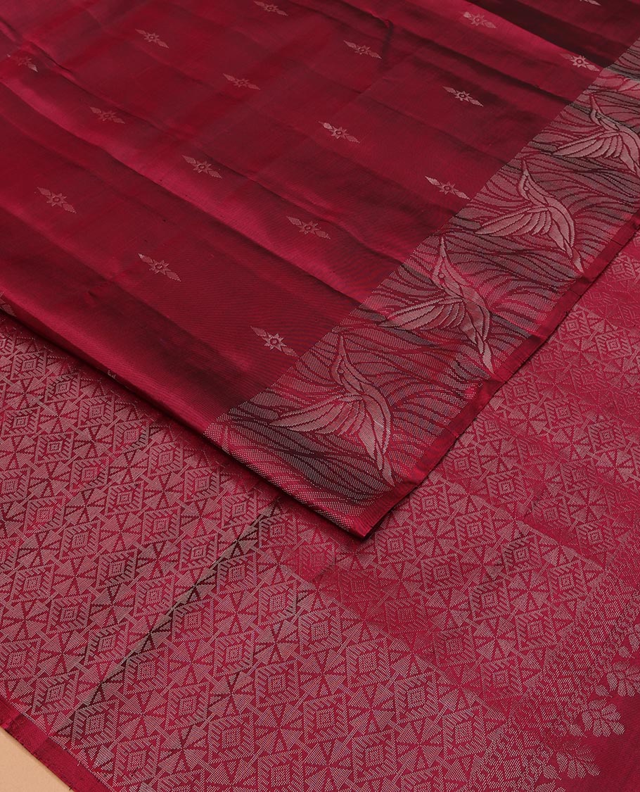 Red Mayuri Soft Silk Saree Subtly Sparkled with Buttas All Over Its Body, Highlighted by Zari Border of Kingfisher Bird Motifs, Pallu Features Geometric Patterns, and Paired with a Matching Blouse