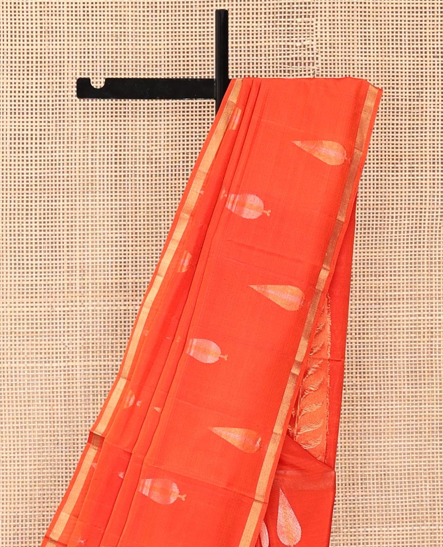Orange Mayuri Soft Silk Saree, Adorned with Pine-Tree Buttas All Over Its Body, Subtle Zari Piping Border, Sparsely Woven Pallu, and Paired with a Matching Blouse