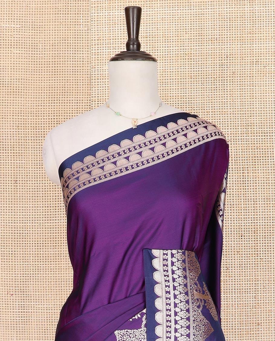 Purple plain mushru silk saree, self-border of scallop design, floral, and tree motifs, and intricately designed pallu