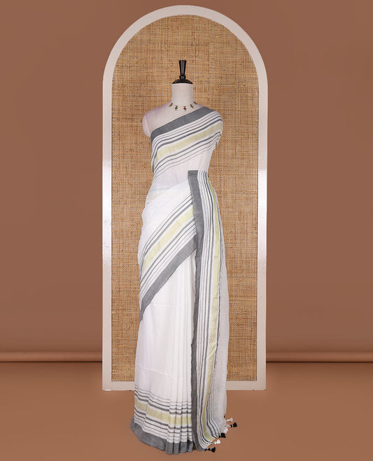 Cream-grey plain design mul mul cotton saree, contrast gold zari horizontally striped border, plain pallu, and plain blouse