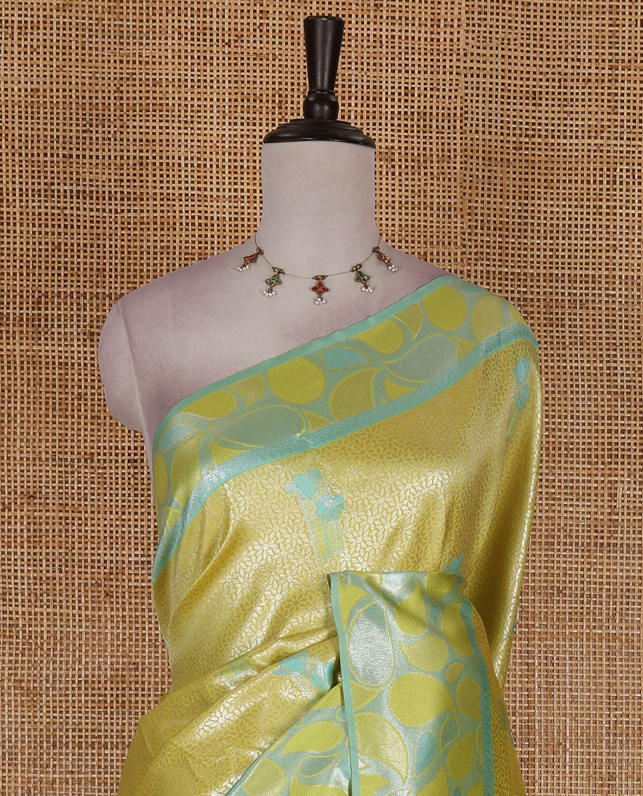 Green jacquard kanchi silk saree, contrast border, and pallu steeped with paisley motifs with contrast zari design blouse