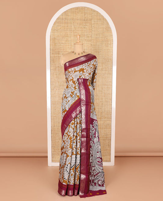 Mustard kalamkari floral vine and peacock printed muslin cotton saree, contrast zari border, kalamkari peacock printed pallu, and a contrast coin buttas printed blouse
