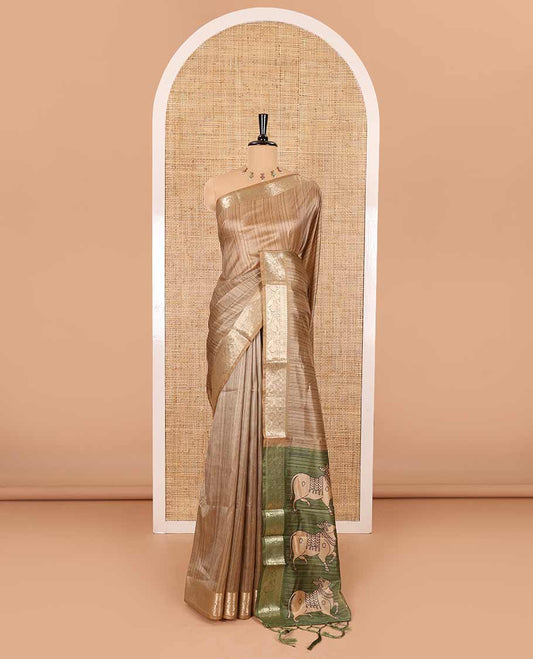 Chikku striped semi-tussar saree, traditional zari border of floral creeper designs, contrast pallu of Pichwai cow print, and contrast Pichwai cow printed blouse