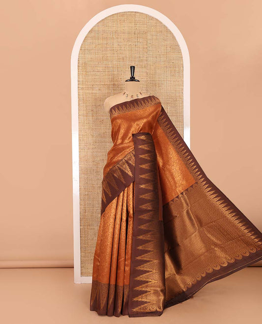 Rust orange-brown floral and bird jacquard kanchi silk saree, contrast temple border, zari-rich jaal pallu, and a jacquard blouse